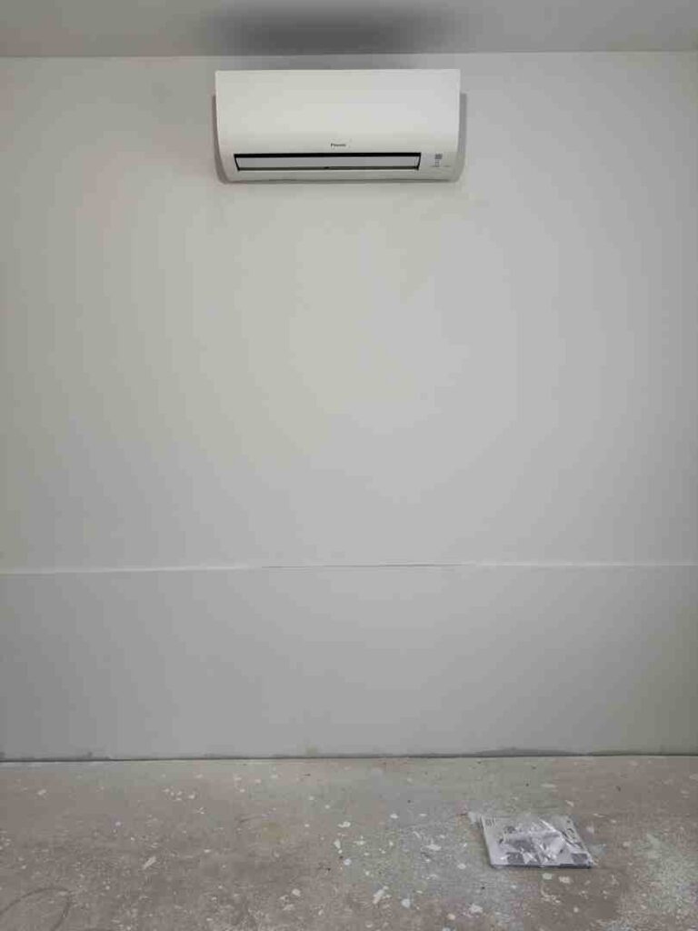 ductless mini split head mounted on wall in modern living room - how many ductless heads do i need