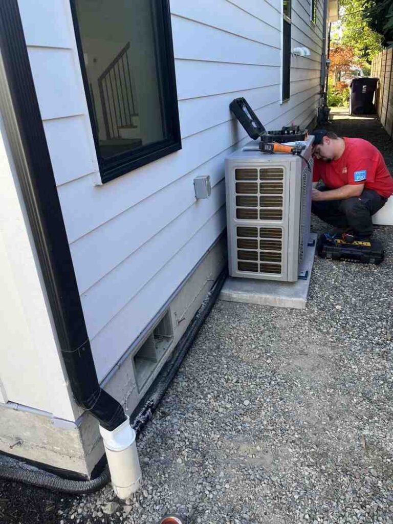 HVAC technician inspecting aging outdoor AC unit next to a home - cost of repairing old hvac vs buying new system