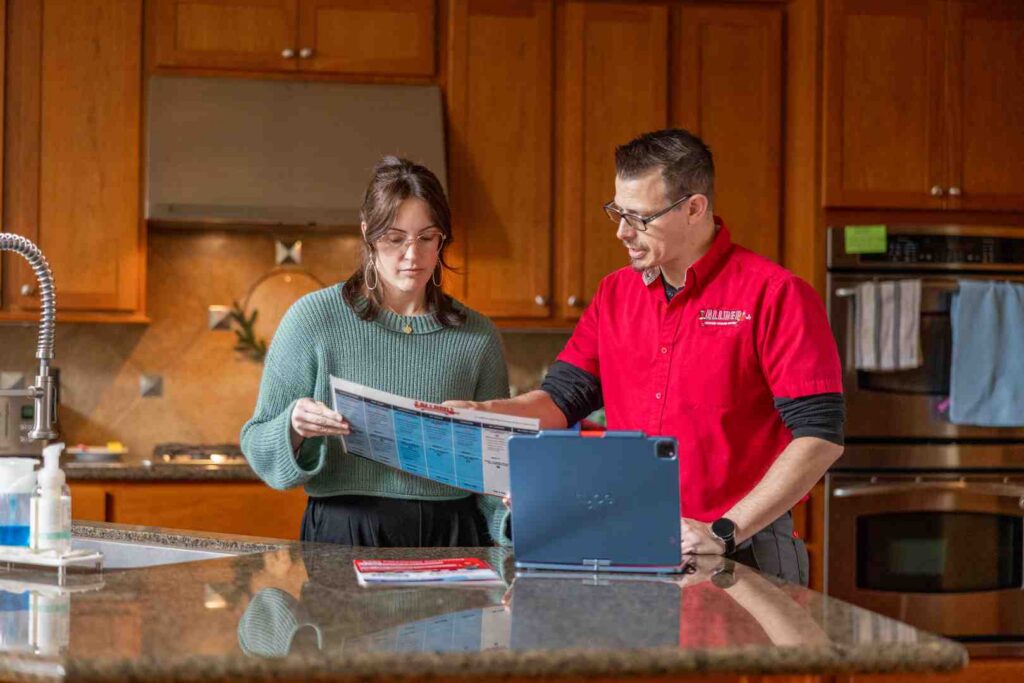 Homeowner in Washington sitting at a kitchen table reviewing energy tax forms and rebate applications - washington energy